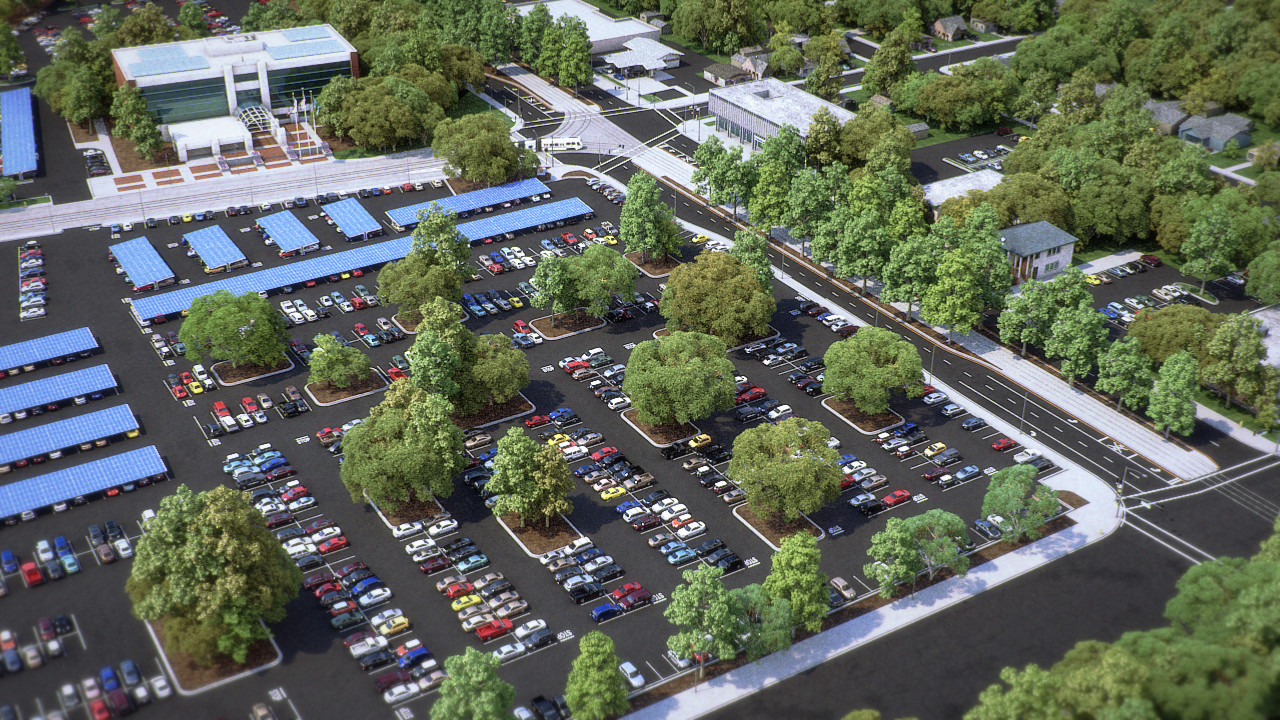 Aerial view of a tree-lined parking lot with solar canopies.